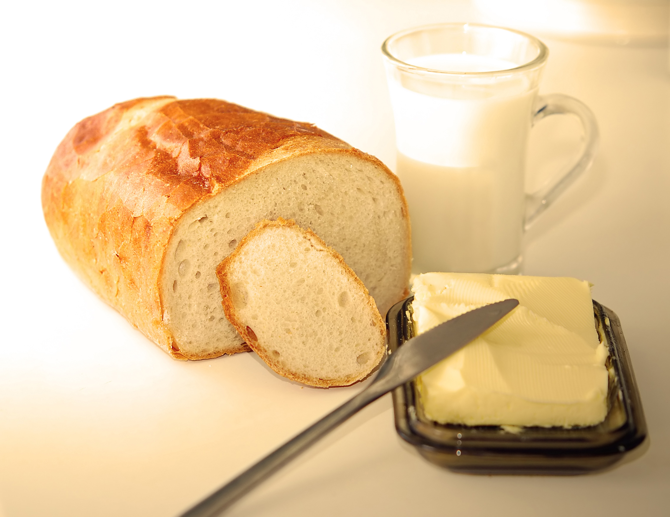 Preparing dinner. A glass of milk, bread, butter